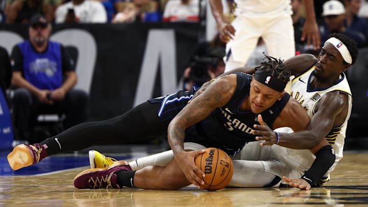 Oct 28, 2024; Orlando, Florida, USA; Orlando Magic forward Paolo Banchero (5) and Indiana Pacers forward Pascal Siakam (43) battle for the ball in the third quarter at Kia Center. Mandatory Credit: Nathan Ray Seebeck-Imagn Images