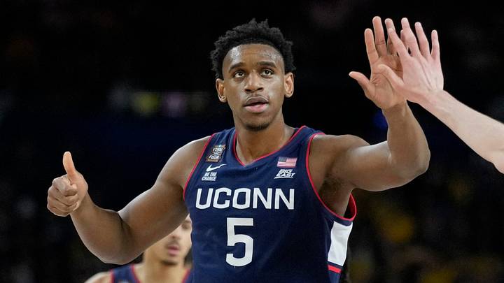 UConn Huskies forwards Tarris Reed Jr. (5) and Alex Karaban (11) high five Monday, April 6, 2026, during the NCAA men's basketball tournament national championship game against the Michigan Wolverines at Lucas Oil Stadium in Indianapolis.