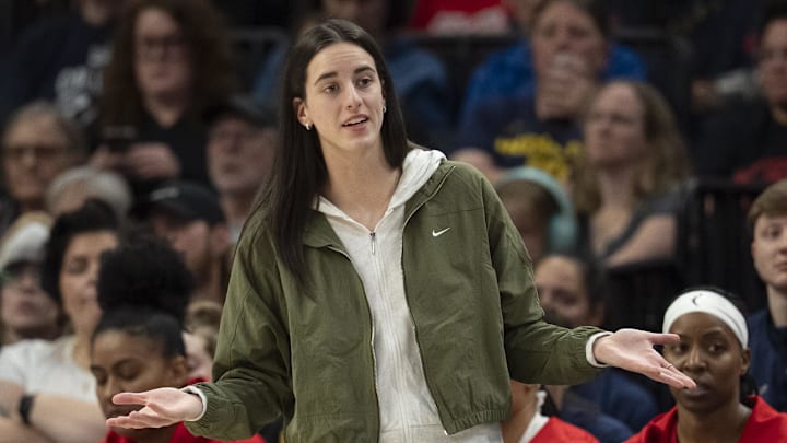 Aug 24, 2025; Minneapolis, Minnesota, USA; Indiana Fever guard Caitlin Clark (22) looks on from the bench against the Minnesota Lynx in the second half at Target Center. Mandatory Credit: Jesse Johnson-Imagn Images