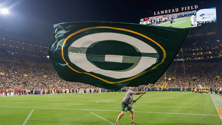 After a Green Bay Packers touchdown, a man waves a flag in the end zone during the second quarter against the Cardinals. After a Green Bay Packers touchdown, a man waves a flag in the end zone during the second quarter against the Cardinals.