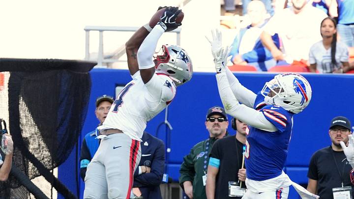 Oct 4, 2026; Orchard Park, New York, USA;  New England Patriots safety Craig Woodson (4) intercepts a pass intended Buffalo Bills wide receiver Josh Palmer (5) during the fourth quarter for at New Highmark Stadium.  Mandatory Credit: Gregory Fisher-Imagn Images