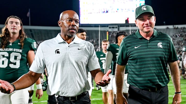 Michigan State football coach Jonathan Smith, right, talks with athletic director Alan Haller after MSU's victory over Florida Atlantic on Friday, Aug. 30, 2024, at Spartan Stadium in East Lansing.