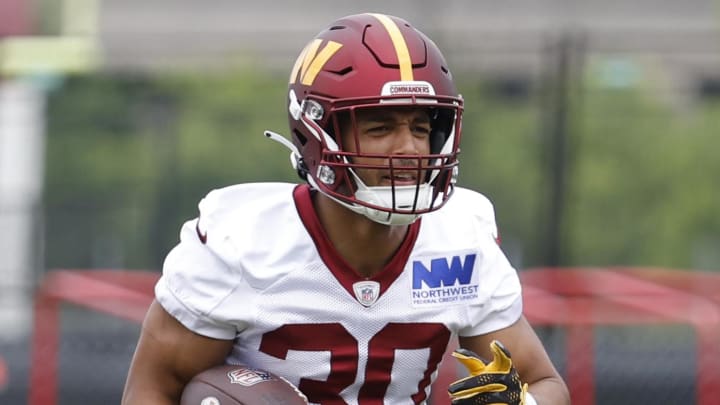 Jun 5, 2024; Ashburn, VA, USA; Washington Commanders running back Austin Ekeler (30) carries the ball during OTA workouts at Commanders Park. Mandatory Credit: Geoff Burke-USA TODAY Sports