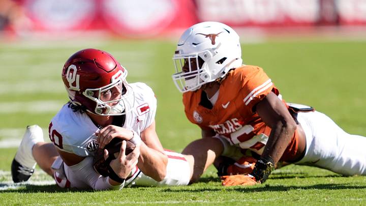 Oklahoma Sooners quarterback John Mateer (10) is tackled by Texas Longhorns linebacker Ty'Anthony Smith (26) in the first half of the Red River Rivalry college football game between the University of Oklahoma Sooners and the Texas Longhorn at the Cotton Bowl Stadium in Dallas, Texas, Saturday, Oct. 11, 2025. Oklahoma Sooners quarterback John Mateer (10) is tackled by Texas Longhorns linebacker Ty'Anthony Smith (26) in the first half of the Red River Rivalry college football game between the University of Oklahoma Sooners and the Texas Longhorn at the Cotton Bowl Stadium in Dallas, Texas, Saturday, Oct. 11, 2025.
