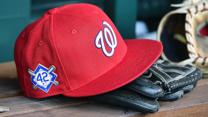 Red Washington Nationals hat on top of a black mitt