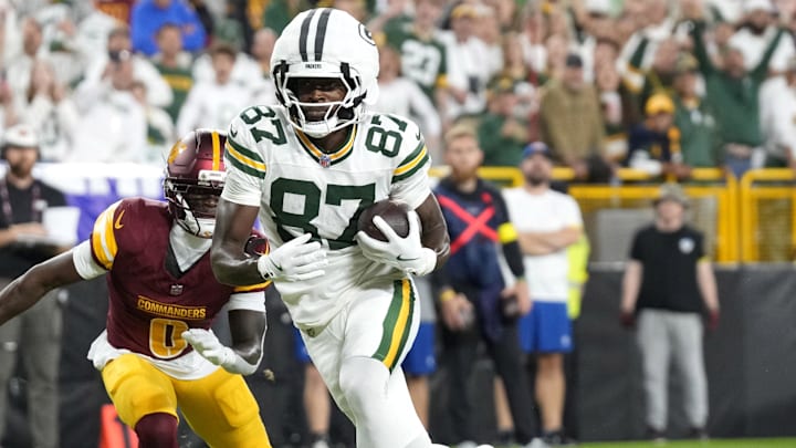 Sep 11, 2025; Green Bay, Wisconsin, USA; Green Bay Packers wide receiver Romeo Doubs (87) scores a touchdown against Washington Commanders cornerback Mike Sainristil (0) in the first quarter at Lambeau Field. Mandatory Credit: Jeff Hanisch-Imagn Images