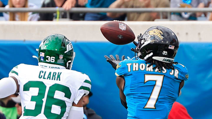 Jacksonville Jaguars wide receiver Brian Thomas Jr. (7) hauls in a touchdown score against New York Jets safety Chuck Clark (36) before an NFL football matchup Sunday, Dec. 15, 2024 at EverBank Stadium in Jacksonville, Fla. [Corey Perrine/Florida Times-Union]
