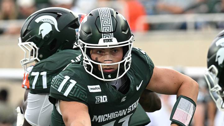 Oct 10, 2026; East Lansing, Michigan, USA; Michigan State Spartans quarterback Alessio Milivojevic (11) hands the ball to running back Marvis Parrish (21) during the third quarter against the Illinois Fighting Illini at Spartan Stadium. Mandatory Credit: Dale Young-Imagn Images Oct 10, 2026; East Lansing, Michigan, USA; Michigan State Spartans quarterback Alessio Milivojevic (11) hands the ball to running back Marvis Parrish (21) during the third quarter against the Illinois Fighting Illini at Spartan Stadium. Mandatory Credit: Dale Young-Imagn Images