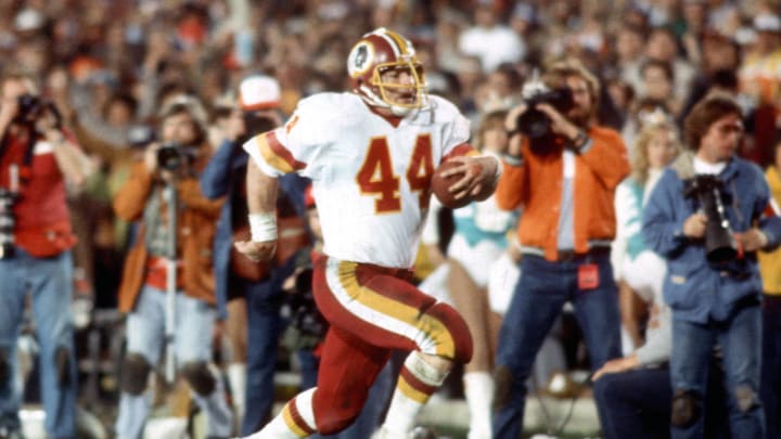 Jan 30, 1983; Pasadena, CA, USA; FILE PHOTO; Washington Redskins running back  John Riggins (44) breaks free on a 43 yard touchdown run against the Miami Dolphins during Super Bowl XVII at the Rose Bowl. Riggins was named the games most valuable player as he rushed for 166 yards on 38 carries and a touchdown. The Redskins defeated the Dolphins 27-17. Mandatory Credit: Tony Tomsic-USA TODAY Sports