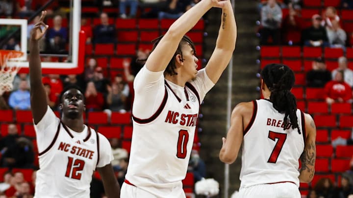 Dec 6, 2025; Raleigh, North Carolina, USA; NC State Wolfpack guard Jordan Snell (0) celebrates a 3-point shot during the second half of the game against the Liberty Flames at Lenovo Center. Mandatory Credit: Jaylynn Nash-Imagn Images