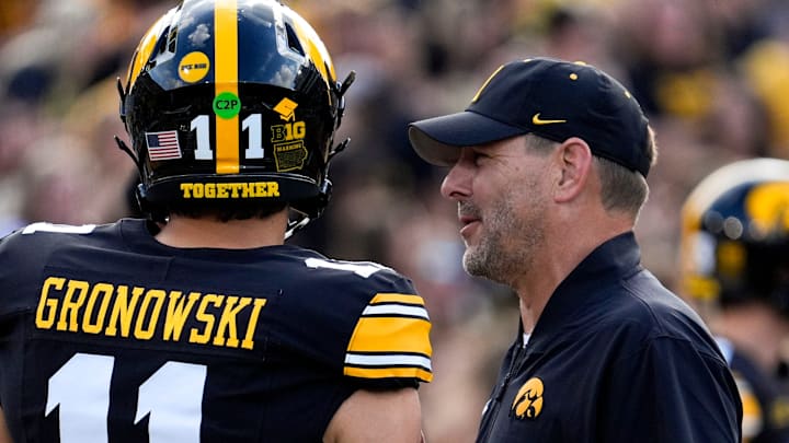 Iowa offensive coordinator Tim Lester talks to Iowa Hawkeyes quarterback Mark Gronowski (11) during warmups Aug. 30, 2025 at Kinnick Stadium in Iowa City, Iowa.