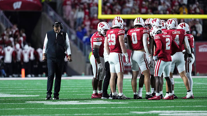 Oct 11, 2025; Madison, Wisconsin, USA; Wisconsin Badgers head coach Luke Fickell and his team take a timeout in the second half against the Iowa Hawkeyes at Camp Randall Stadium.