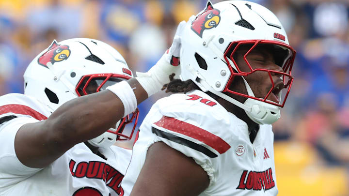 Louisville Cardinals defensive lineman Rene Konga celebrates his sack with defensive lineman Jerry Lawson. Louisville Cardinals defensive lineman Rene Konga celebrates his sack with defensive lineman Jerry Lawson.