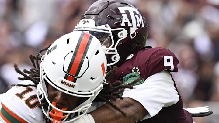 Miami Hurricanes wide receiver Malachi Toney (10) is tackled by Texas A&M Aggies defensive end Cashius Howell (9) 