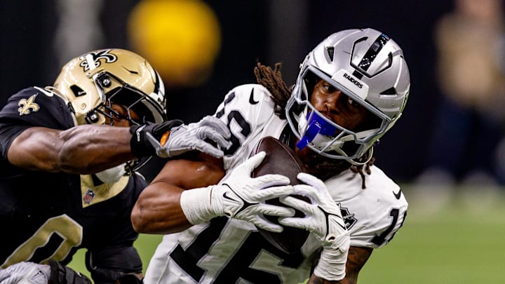 Dec 29, 2024; New Orleans, Louisiana, USA;  Las Vegas Raiders wide receiver Jakobi Meyers (16) catches a pass against New Orleans Saints safety Ugo Amadi (0) during the first half at Caesars Superdome. Mandatory Credit: Stephen Lew-Imagn Images