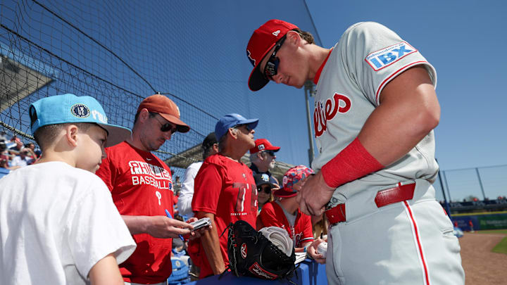 Mar 2, 2025; Dunedin, Florida, USA; Philadelphia Phillies infielder Aidan Miller (81) signs autographs for fans before a game against the Toronto Blue Jays during spring training at TD Ballpark. 