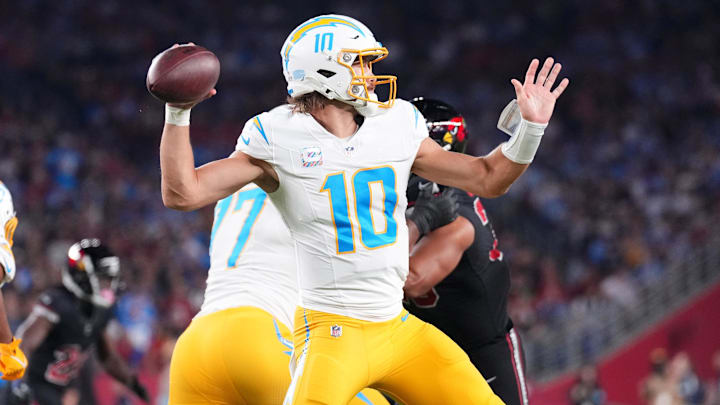 Oct 21, 2024; Glendale, Arizona, USA; Los Angeles Chargers quarterback Justin Herbert (10) throws against the Arizona Cardinals during the first half at State Farm Stadium. Mandatory Credit: Joe Camporeale-Imagn Images