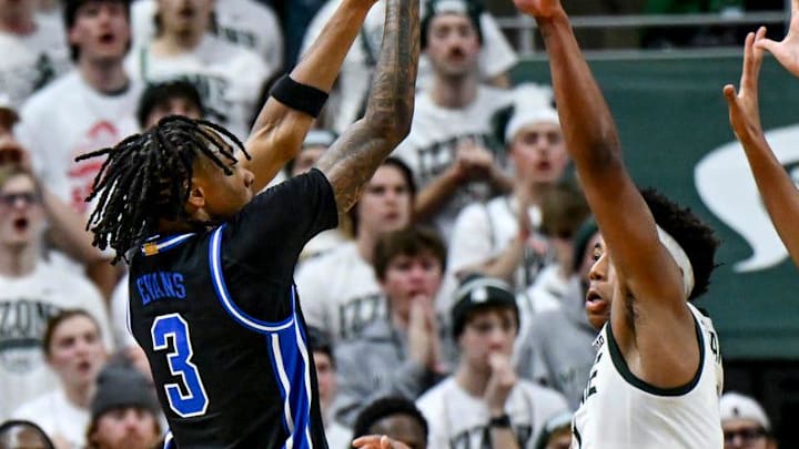 Duke's Isaiah Evans, left, shoots a three pointer before getting fouled by Jordan Scott, right, during the second half on Saturday, Dec. 6, 2025, at the Breslin Center in East Lansing. Duke's Isaiah Evans, left, shoots a three pointer before getting fouled by Jordan Scott, right, during the second half on Saturday, Dec. 6, 2025, at the Breslin Center in East Lansing.