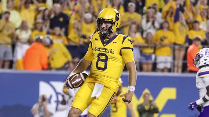 Sep 7, 2024; Morgantown, West Virginia, USA; West Virginia Mountaineers quarterback Nicco Marchiol (8) runs the ball for a touchdown during the fourth quarter against the Albany Great Danes at Mountaineer Field at Milan Puskar Stadium. Mandatory Credit: Ben Queen-Imagn Images