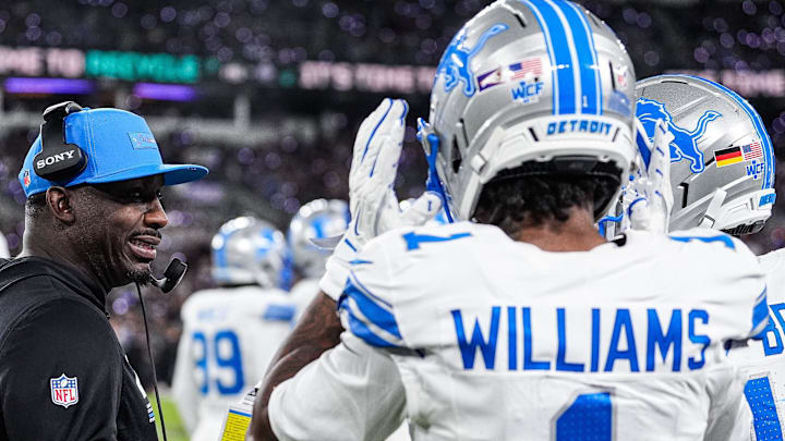 Detroit Lions assistant head coach and wide receivers coach Scottie Montgomery talks to wide receiver Jameson Williams (1) and wide receiver Amon-Ra St. Brown (14) before a play during the second half at M&T Bank Stadium in Baltimore, Md. on Monday, Sept. 22, 2025.