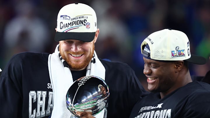 Feb 8, 2026; Santa Clara, CA, USA; Seattle Seahawks quarterback Sam Darnold (14) and running back Kenneth Walker III (9) celebrate with the Vince Lombardi trophy after defeating the New England Patriots in Super Bowl LX at Levi's Stadium. Mandatory Credit: Mark J. Rebilas-Imagn Images