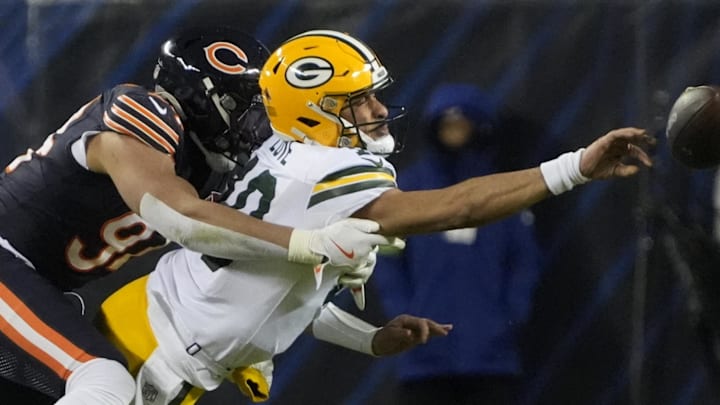 Green Bay Packers quarterback Jordan Love throws the ball as he is hit from behind druing the playoff loss at the Bears.