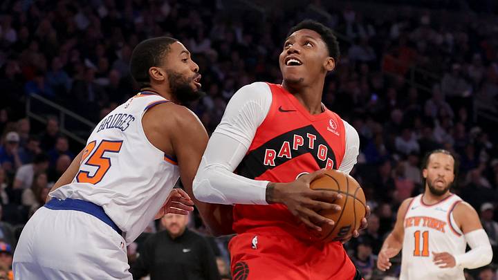 Dec 23, 2024; New York, New York, USA; Toronto Raptors guard RJ Barrett (9) drives to the basket against New York Knicks forward Mikal Bridges (25) Mandatory Credit: Brad Penner-Imagn Images