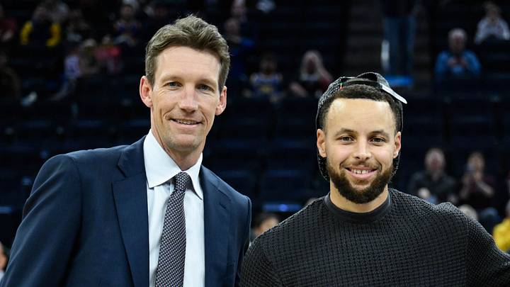 San Francisco, California, USA; Golden State Warriors guard Stephen Curry, center, accepts a ball honoring his All-Star Game selection from Golden State Warriors general manager Mike Dunleavy, left, and 12-year season ticket member Casey Kaminsky, right, before the game against the San Antonio Spurs at Chase Center. Mandatory Credit: Eakin Howard-Imagn Images