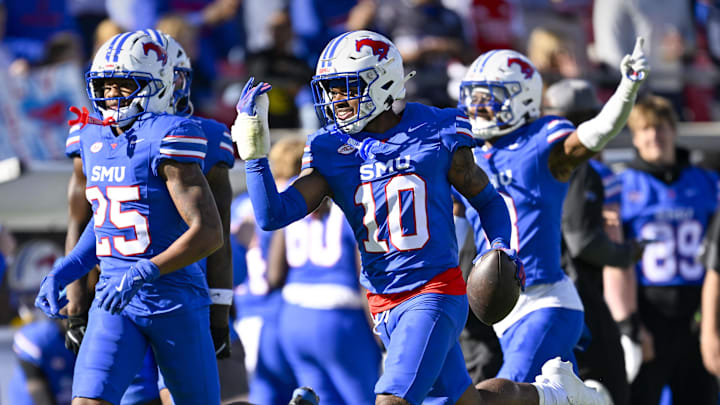The SMU defense celebrates an interception by safety Tyren Polley against Louisville.