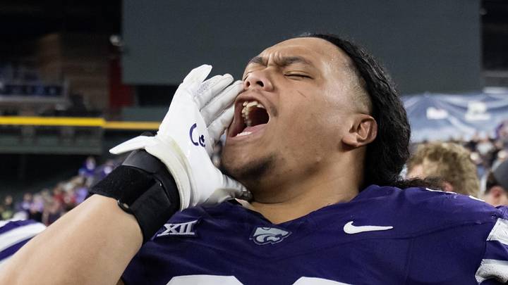 Kansas State Wildcats defensive tackle Uso Seumalo (99) celebrates after defeating the Rutgers Scarlet Knights.