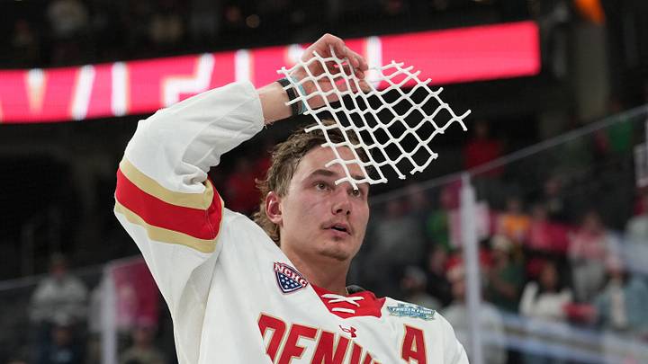 Apr 11, 2026; Las Vegas, Nevada, United States; Denver Pioneers forward Samu Salminen skates with parts of a cut net after defeating the Wisconsin Badgers in the championship game of the NCAA men's ice hockey Frozen Four at T-Mobile Arena. 