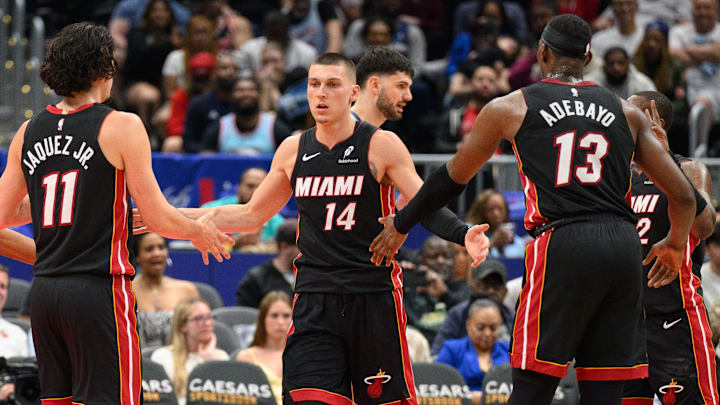 Mar 31, 2025; Washington, District of Columbia, USA; Miami Heat guard Tyler Herro (14) reacts with center Bam Adebayo (13), and guard Jaime Jaquez Jr. (11) during the third quarter against the Washington Wizards at Capital One Arena. Mandatory Credit: Reggie Hildred-Imagn Images
