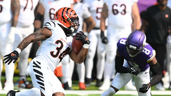 Sep 21, 2025; Minneapolis, Minnesota, USA; Cincinnati Bengals running back Samaje Perine (34) carries the ball as Minnesota Vikings cornerback Jeff Okudah (8) defends during the first half at U.S. Bank Stadium. Mandatory Credit: Jeffrey Becker-Imagn Images