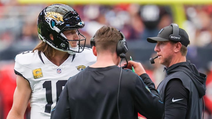 Nov 9, 2025; Houston, Texas, USA; Jacksonville Jaguars quarterback Trevor Lawrence (16) talks with head coach Liam Coen during the first half of a game against the Houston Texans at NRG Stadium. Mandatory Credit: Thomas Shea-Imagn Images