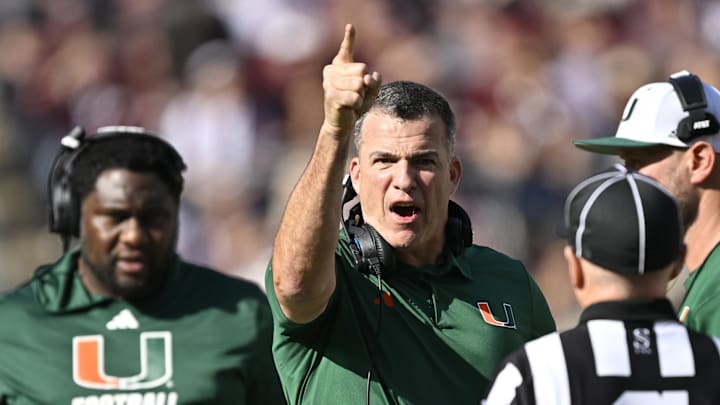 Dec 20, 2025; College Station, TX, USA; Miami Hurricanes head coach Mario Cristobal talks with an official during the second half of the first round game of the CFP National Playoff against the Texas A&M Aggies at Kyle Field. Mandatory Credit: Jerome Miron-Imagn Images