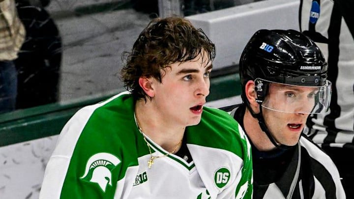 Michigan State's Porter Martone is escorted away from the scuffle during the second period in the game against Notre Dame on Thursday, Feb. 19, 2026, at the Munn Ice Arena in East Lansing.