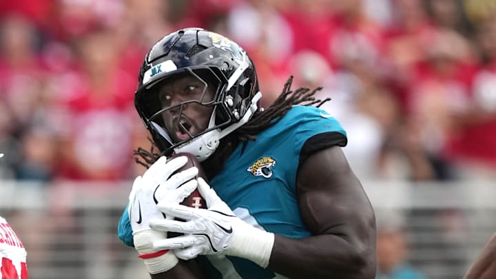 Sep 28, 2025; Santa Clara, California, USA; Jacksonville Jaguars linebacker Devin Lloyd (center) catches a bobbled ball by San Francisco 49ers running back Christian McCaffrey (left) for an interception during the second quarter at Levi's Stadium. Mandatory Credit: Darren Yamashita-Imagn Images Sep 28, 2025; Santa Clara, California, USA; Jacksonville Jaguars linebacker Devin Lloyd (center) catches a bobbled ball by San Francisco 49ers running back Christian McCaffrey (left) for an interception during the second quarter at Levi's Stadium. Mandatory Credit: Darren Yamashita-Imagn Images