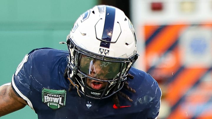 UConn's Cam Edwards carries the ball during a game vs. Army in the Fenway Bowl at Fenway Park in Boston on Saturday, Dec. 27, 2025.