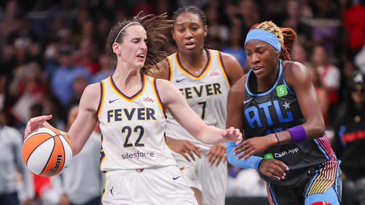 May 22, 2025; Atlanta, Georgia, USA; Indiana Fever guard Caitlin Clark (22) is fouled by Atlanta Dream guard Rhyne Howard (10) in the fourth quarter at State Farm Arena. Mandatory Credit: Brett Davis-Imagn Images