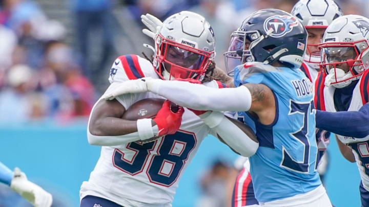 New England Patriots running back Rhamondre Stevenson (38) is stopped by Tennessee Titans safety Amani Hooker (37) during the first quarter at Nissan Stadium in Nashville, Tenn., Sunday, Oct. 19, 2025.