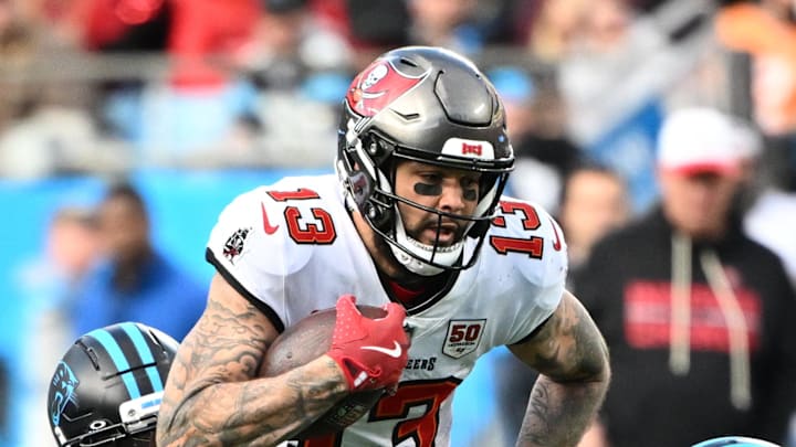 Tampa Bay Buccaneers wide receiver Mike Evans (13) with the ball as Carolina Panthers safety Nick Scott (21) and linebacker Christian Rozeboom (56) defend in the fourth quarter at Bank of America Stadium. Mandatory Credit: Bob Donnan-Imagn Images