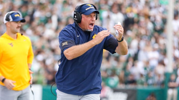 Sep 6, 2025; Athens, Ohio, USA; West Virginia Mountaineers head coach Rich Rodriguez calls a timeout during the second quarter against the Ohio Bobcats at Peden Stadium. Mandatory Credit: Ben Queen-Imagn Images