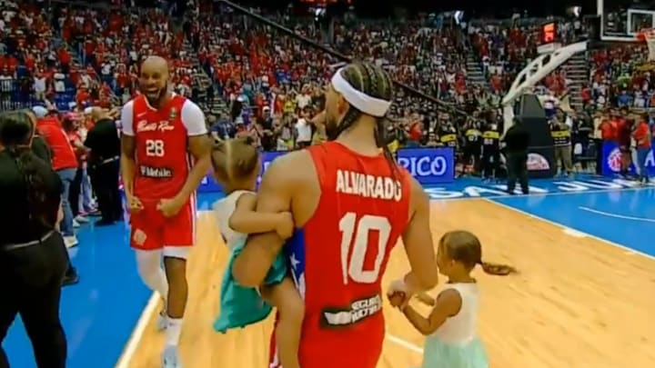 Jose Alvarado with his daughters after an Olympic qualifying game in 2024