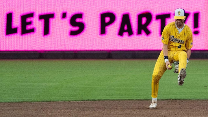 Savannah Bananas Ryan Cox (6) passes the ball under his leg to throw to first base during their game against the Party Animals on Thursday, Aug. 1, 2024 for their first game of the series at Louisville Slugger Field in Louisville, Ky. Savannah Bananas Ryan Cox (6) passes the ball under his leg to throw to first base during their game against the Party Animals on Thursday, Aug. 1, 2024 for their first game of the series at Louisville Slugger Field in Louisville, Ky.