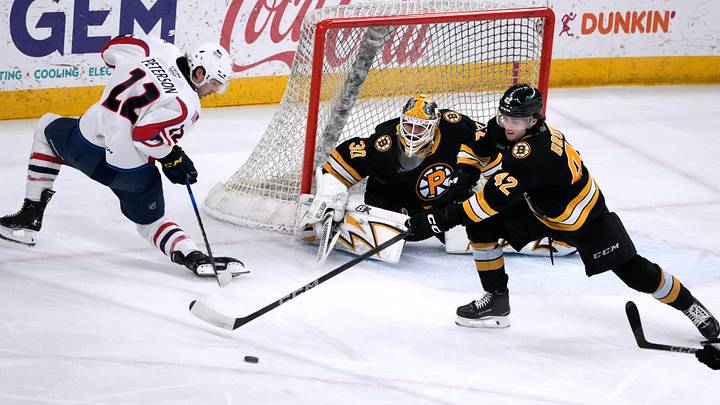 Providence Bruins goalie Michael DiPietro and defender Frederic Brunet deflect the puck from Thunderbird Dylan Peterson away from the Providence goal. Providence Bruins goalie Michael DiPietro and defender Frederic Brunet deflect the puck from Thunderbird Dylan Peterson away from the Providence goal.