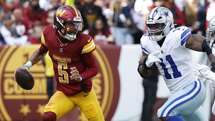 Nov 24, 2024; Landover, Maryland, USA; Washington Commanders quarterback Jayden Daniels (5) scrambles from Dallas Cowboys linebacker Micah Parsons (11) and Cowboys defensive tackle Osa Odighizuwa (97) at Northwest Stadium. Mandatory Credit: Geoff Burke-Imagn Images