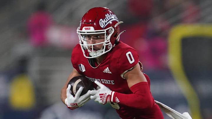 Nov 25, 2022; Fresno, California, USA; Fresno State Bulldogs wide receiver Mac Dalena (0) runs with the ball after a catch in front of Wyoming Cowboys strong safety Wyett Ekeler (31) in the first quarter at Valley Children's Stadium. Mandatory Credit: Cary Edmondson-Imagn Images Nov 25, 2022; Fresno, California, USA; Fresno State Bulldogs wide receiver Mac Dalena (0) runs with the ball after a catch in front of Wyoming Cowboys strong safety Wyett Ekeler (31) in the first quarter at Valley Children's Stadium. Mandatory Credit: Cary Edmondson-Imagn Images