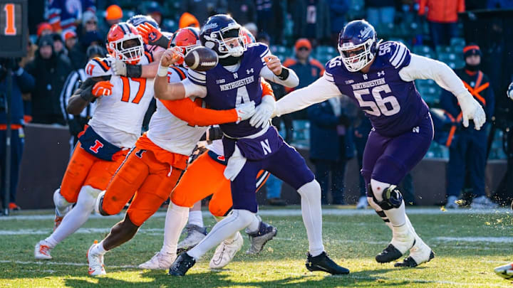 Illinois defenders, including linebacker Gabe Jacas (17), wrap up Northwestern quarterback Ryan Boe (4) and force a fumble in the Illini's 38-28 win at Wrigley Field in Chicago on Nov. 30, 2024. Illinois defenders, including linebacker Gabe Jacas (17), wrap up Northwestern quarterback Ryan Boe (4) and force a fumble in the Illini's 38-28 win at Wrigley Field in Chicago on Nov. 30, 2024.