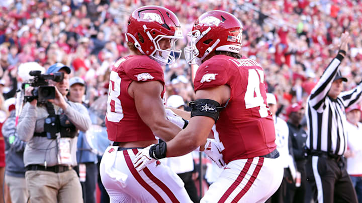 Arkansas Razorbacks tight end Rohan Jones (88) celebrates with tight end Maddox Lassiter (47) after accomplishing an immense feat of athleticism