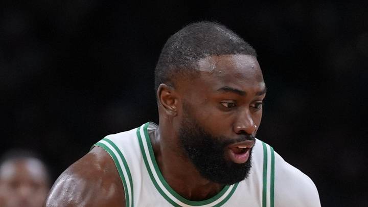 Boston Celtics guard Jaylen Brown returns the ball against Toronto Raptors guard Immanuel Quickley.